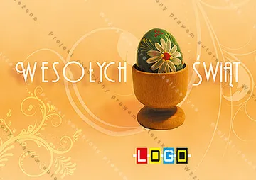 Ciemnozielone jajo we wzorze kwiatów w drewnianym pucharze, tło w pomarańczu, jasne litery życzeń po bokach